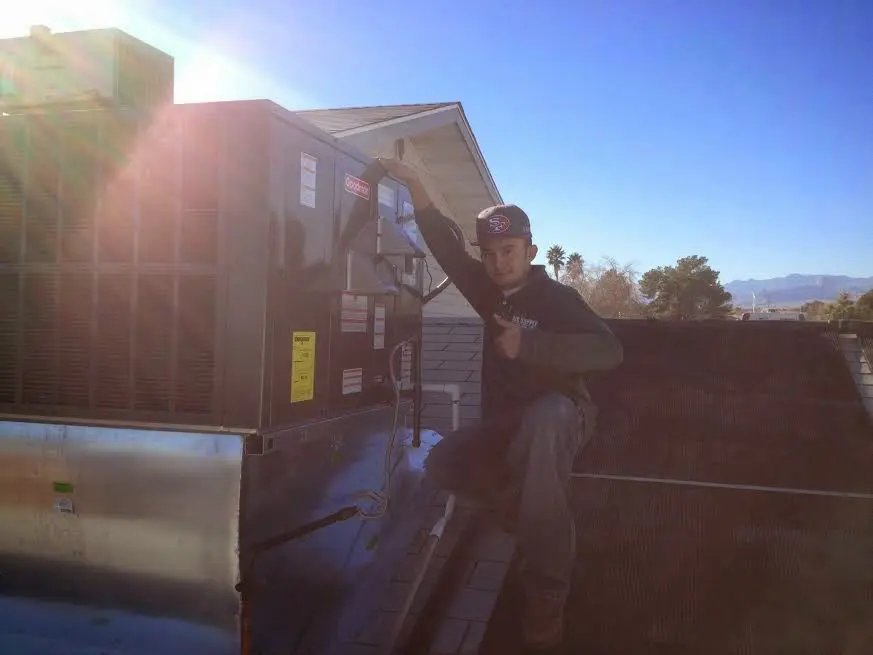 HVAC technician performing HVAC Inspection on a rooftop unit in Warren